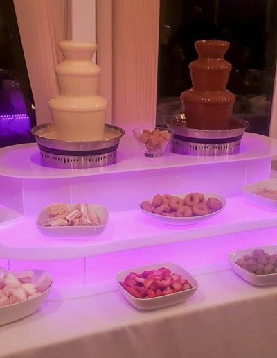 Colour changing 3 tier white and dark chocolate fountain with added sweets, fruits and dips